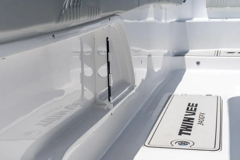 Slide: The Image of 2026 Twin Vee 340 GFX CC boat interior, featuring sleek white design and storage compartments. - 9