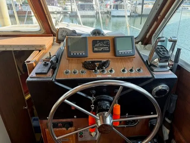 Slide: The Image of 1980 Tollycraft 34 yacht helm station in harbor. - 10