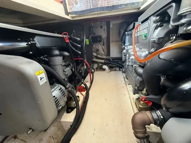 Slide: The Image of Engine room of a 1980 Tollycraft 34 boat with visible engines. - 13