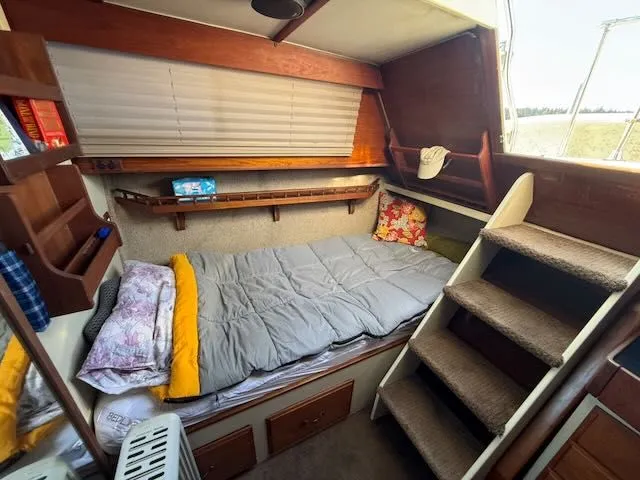 Slide: The Image of Interior of a 1980 Tollycraft 34 with cozy bed and stairs. - 20
