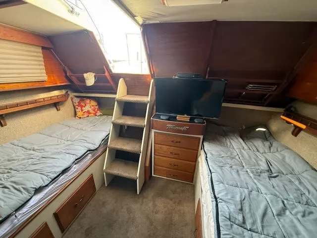 Slide: The Image of Interior of a 1980 Tollycraft 34 with twin beds and TV. - 21