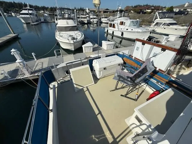 Slide: The Image of 1980 Tollycraft 34 yacht in harbor with deck view. - 25