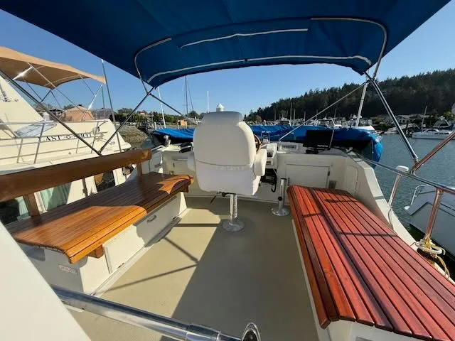 Slide: The Image of 1980 Tollycraft 34 with seating area and blue sunshade. - 27
