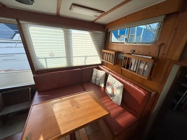 Slide: The Image of Interior of a 1980 Tollycraft 34 with red seating area. - 3