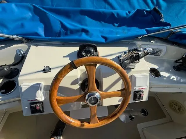 Slide: The Image of Helm of a 1980 Tollycraft 34 with wooden steering wheel. - 30