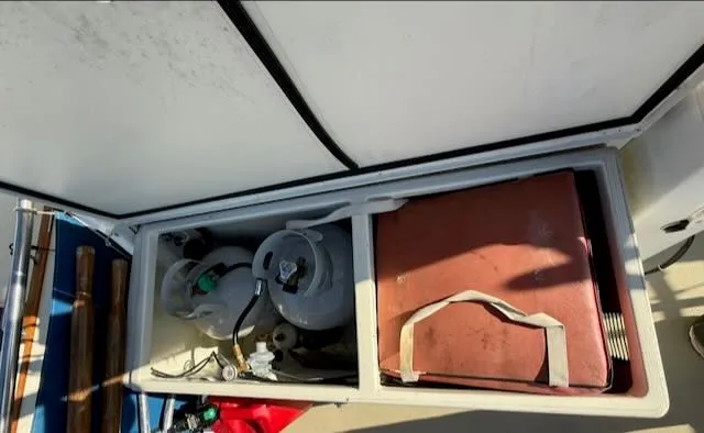 Slide: The Image of Storage compartment on a 1980 Tollycraft 34 boat with gas cylinders. - 33