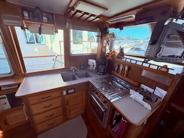 Slide: The Image of Interior of 1980 Tollycraft 34 yacht featuring kitchen and appliances. - 5