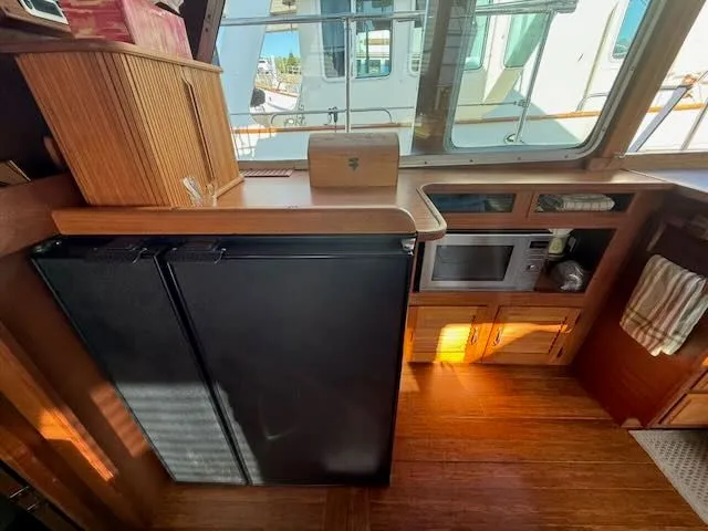 Slide: The Image of Interior of a 1980 Tollycraft 34 yacht with kitchen and refrigerator. - 7