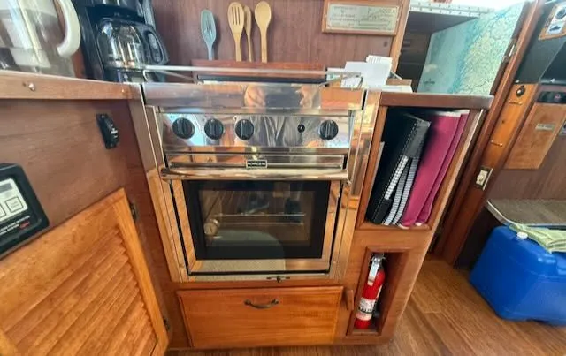 Slide: The Image of 1980 Tollycraft 34 kitchen area with oven and wooden cabinets. - 8