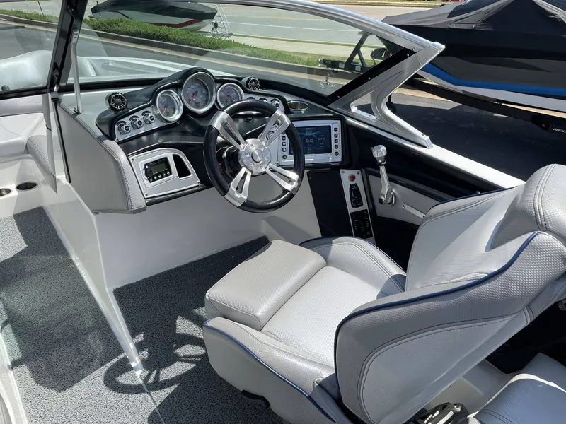 Slide: The Image of Interior of a 2016 MasterCraft X20 boat with steering console. - 21
