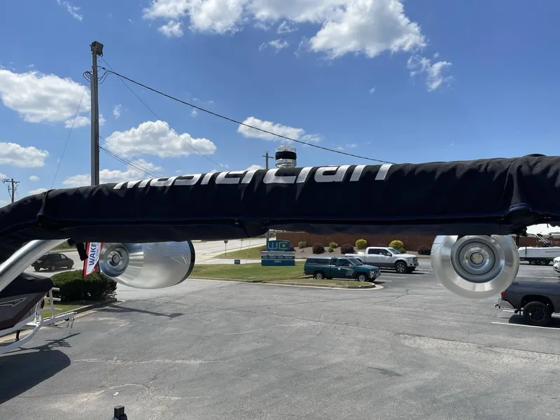 Slide: The Image of 2016 MasterCraft X20 boat with cover and speakers outdoors. - 22