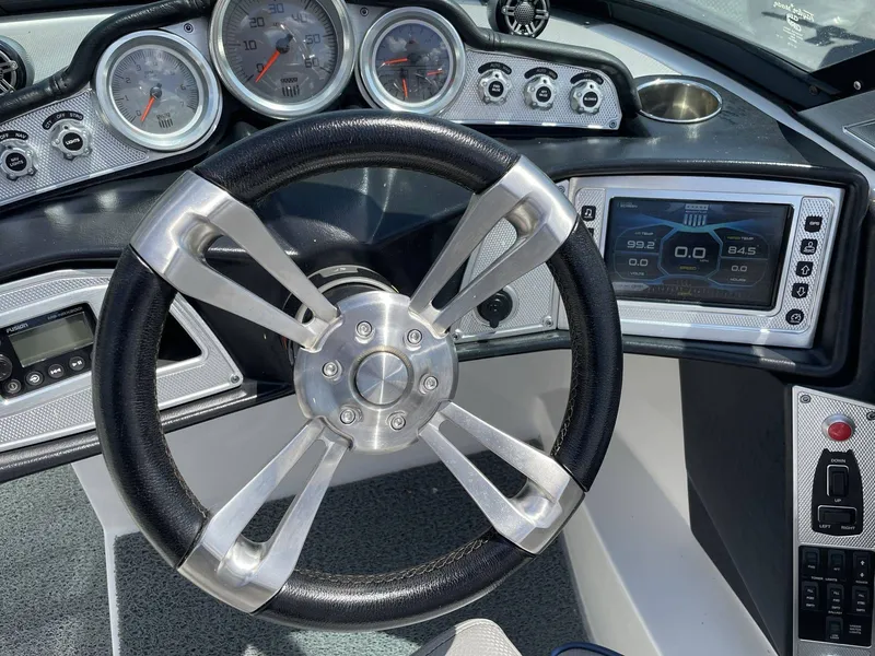 Slide: The Image of Dashboard of a 2016 MasterCraft X20 boat with steering wheel and instruments. - 23