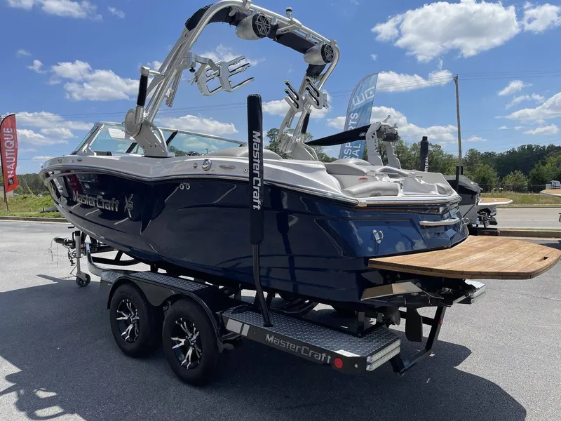 Slide: The Image of 2016 MasterCraft X20 boat on trailer under sunny skies. - 3