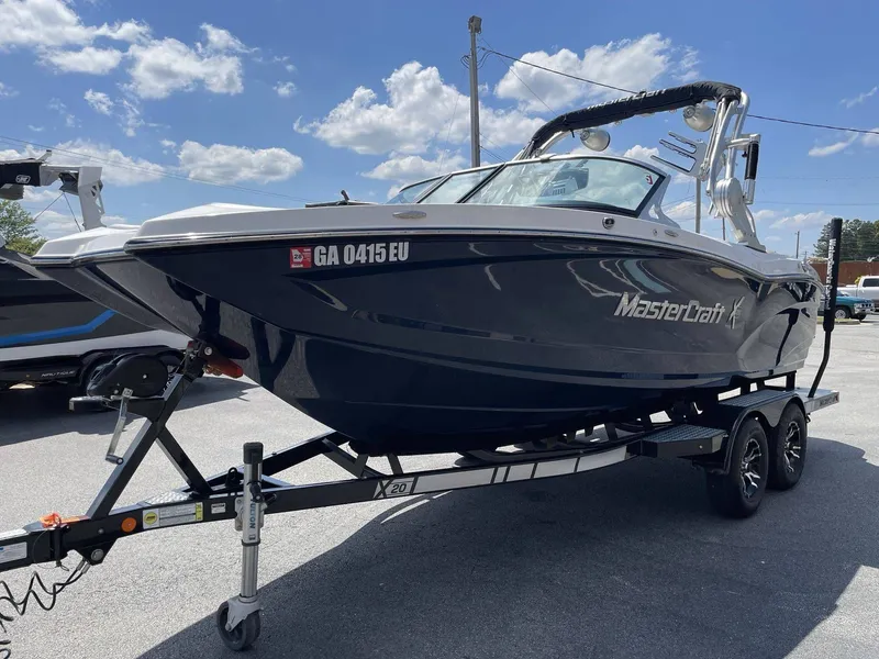 Slide: The Image of 2016 MasterCraft X20 boat on trailer under blue sky. - 4