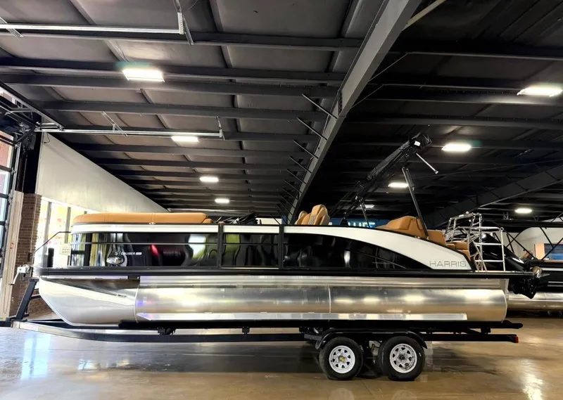The Image of 2026 Harris Cruiser 230 pontoon boat in a warehouse. - 1