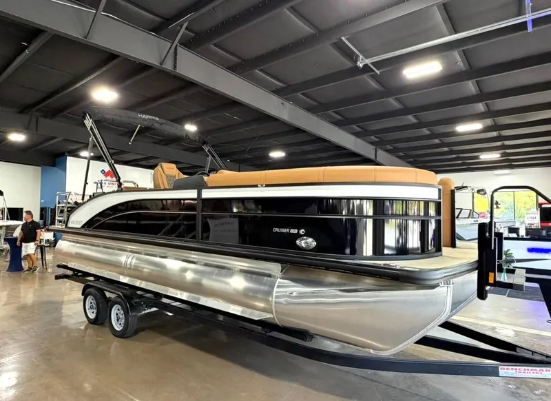 Slide: The Image of 2026 Harris Cruiser 230 pontoon boat in a showroom. - 3