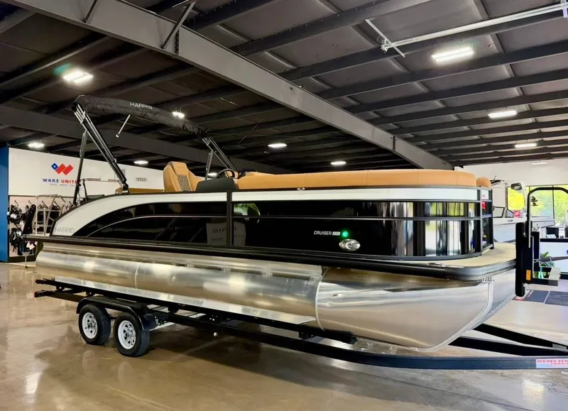 Slide: The Image of 2026 Harris Cruiser 230 pontoon boat in showroom on trailer. - 4