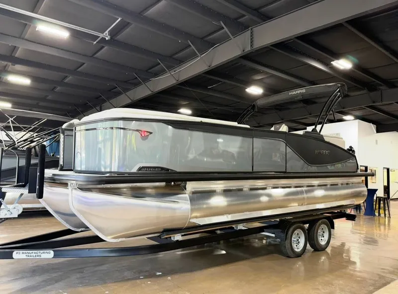 The Image of 2026 Harris Sunliner 230 pontoon boat in a showroom. - 1