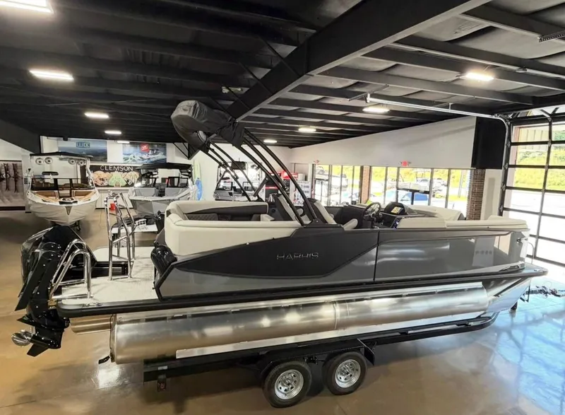 Slide: The Image of 2026 Harris Sunliner 230 pontoon boat in showroom. - 4
