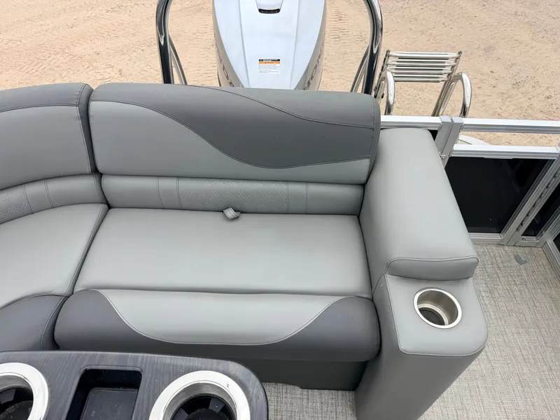 Slide: The Image of 2023 Tahoe LTZ 2385 Elite pontoon boat with gray seating and Honda engine. - 40