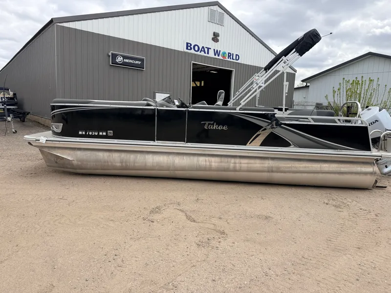 Slide: The Image of 2023 Tahoe LTZ 2385 Elite pontoon boat outside Boat World building. - 48