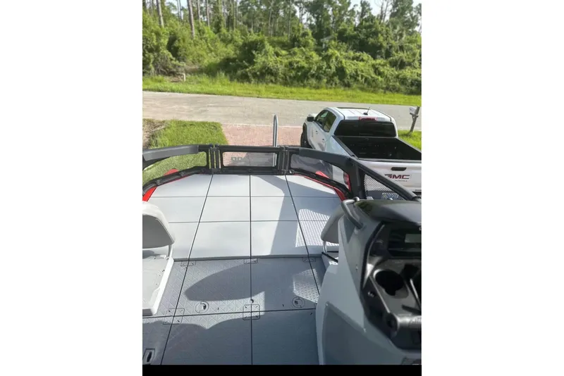 Slide: The Image of 2024 Sea-Doo Switch Cruise 18 interior with a view of a parked GMC truck. - 6