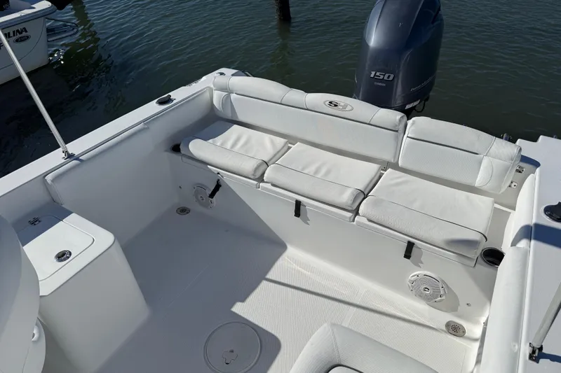 Slide: The Image of 2017 Sea Hunt Escape 211 LE boat interior with cushioned seating and Yamaha 150 engine. - 12