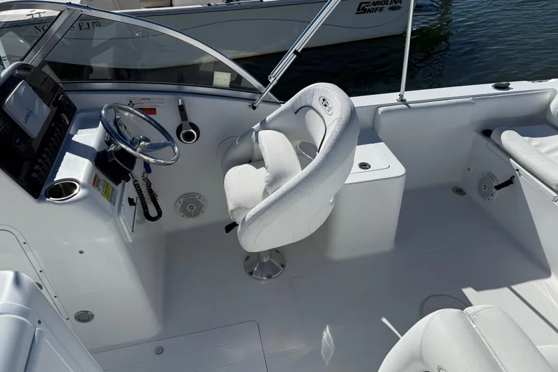 Slide: The Image of 2017 Sea Hunt Escape 211 LE boat interior with steering wheel and seating. - 13