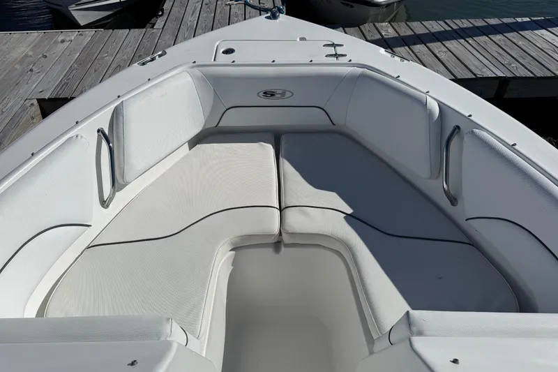 Slide: The Image of 2017 Sea Hunt Escape 211 LE boat interior with white cushioned seating. - 16