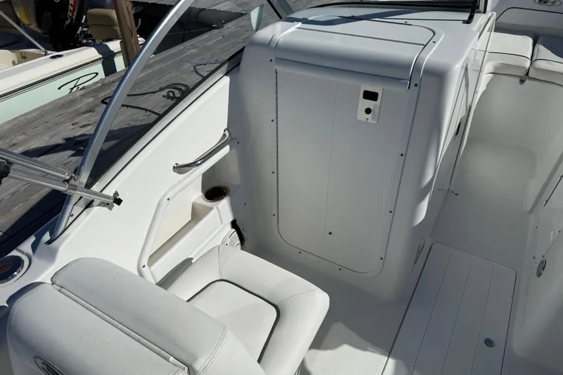 Slide: The Image of 2017 Sea Hunt Escape 211 LE boat interior with white seating and storage compartment. - 17