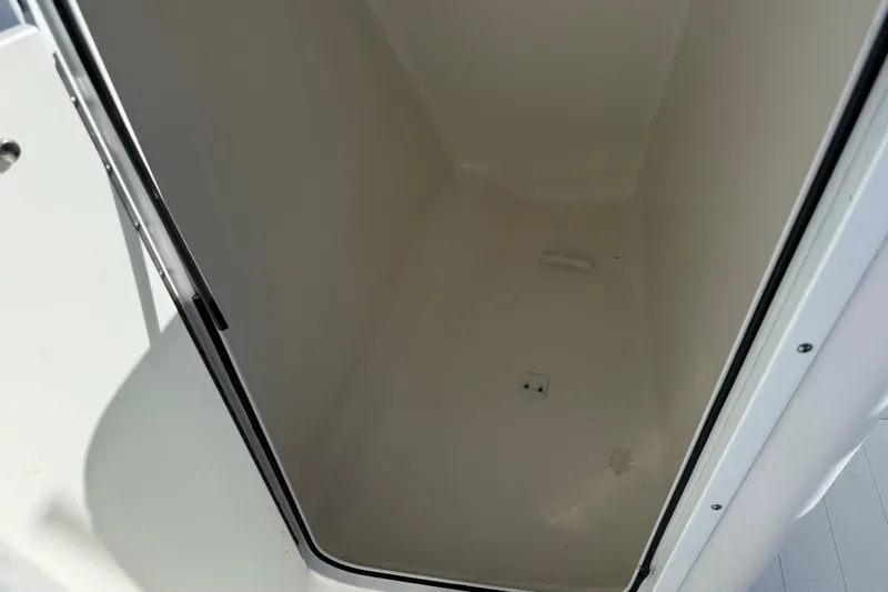 Slide: The Image of 2017 Sea Hunt Escape 211 LE storage compartment interior view. - 18