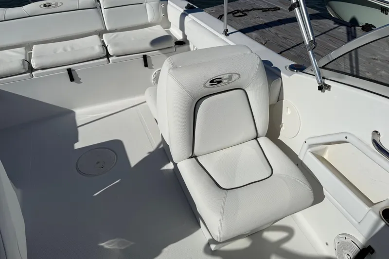 Slide: The Image of 2017 Sea Hunt Escape 211 LE boat interior with white seating and deck details. - 23