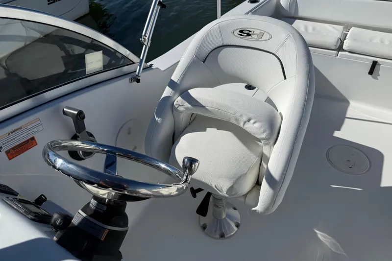 Slide: The Image of 2017 Sea Hunt Escape 211 LE boat interior with steering wheel and captain's chair. - 24