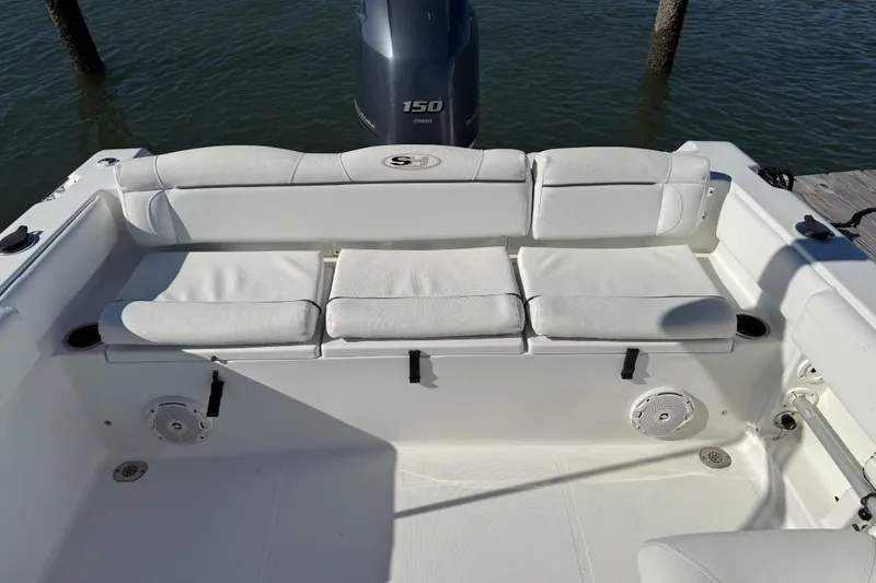 Slide: The Image of 2017 Sea Hunt Escape 211 LE boat interior with white cushioned seating and Yamaha 150 engine. - 26