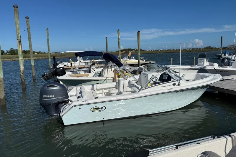 Slide: The Image of 2017 Sea Hunt Escape 211 LE boat docked with Yamaha outboard motor. - 3