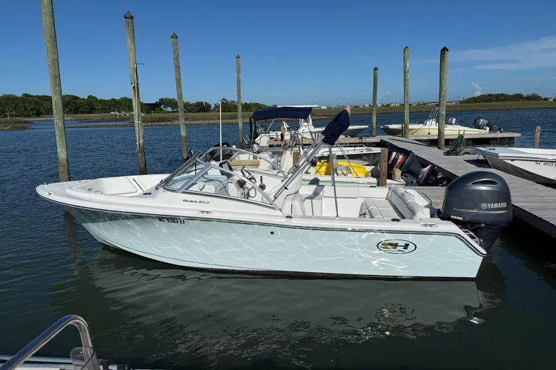 Slide: The Image of 2017 Sea Hunt Escape 211 LE boat docked with Yamaha outboard motor. - 5