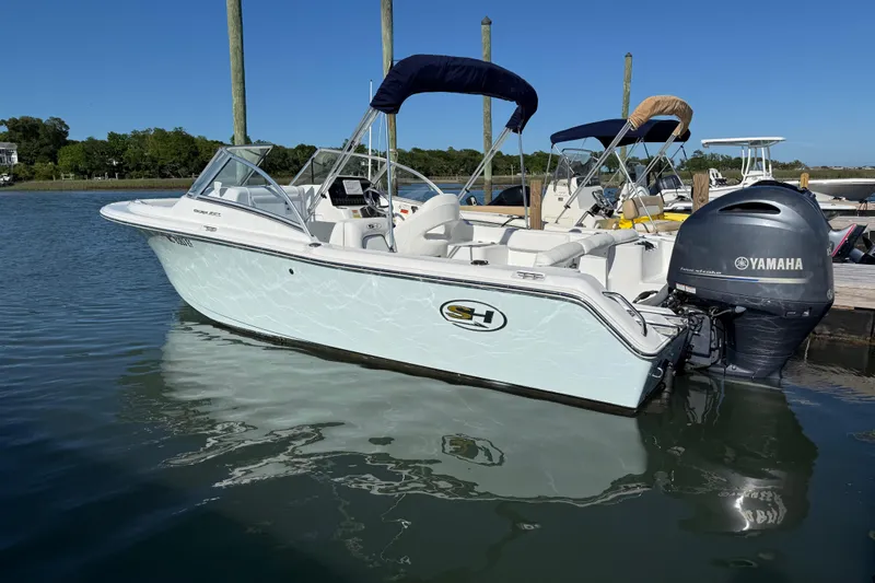 Slide: The Image of 2017 Sea Hunt Escape 211 LE boat docked with Yamaha outboard motor. - 6