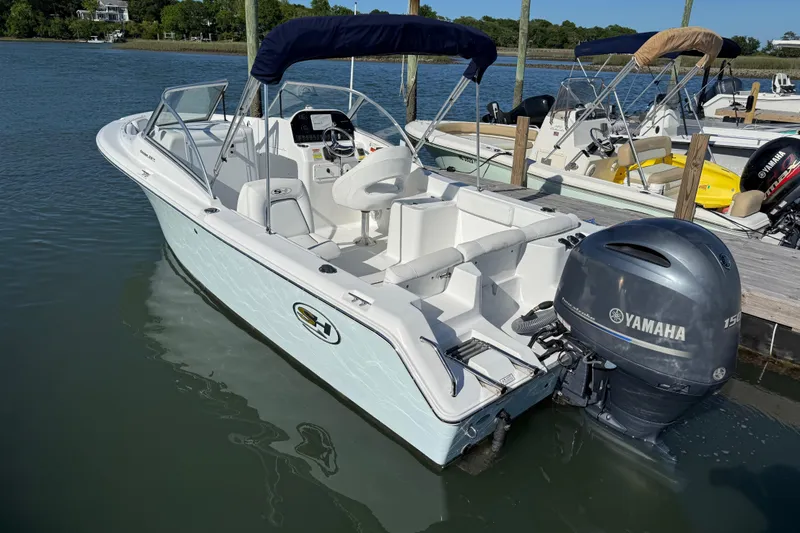 Slide: The Image of 2017 Sea Hunt Escape 211 LE boat docked with Yamaha outboard motor. - 7