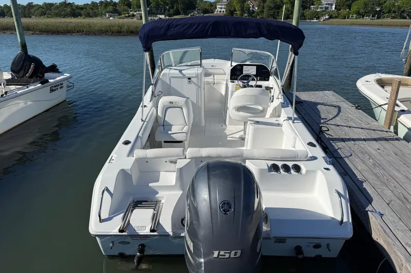 Slide: The Image of 2017 Sea Hunt Escape 211 LE boat docked, featuring spacious seating and Yamaha 150 engine. - 9