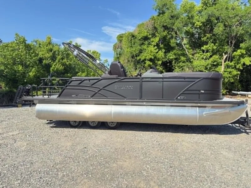 Slide: The Image of 2026 Sylvan X3 CLZ DH pontoon boat parked outdoors. - 27