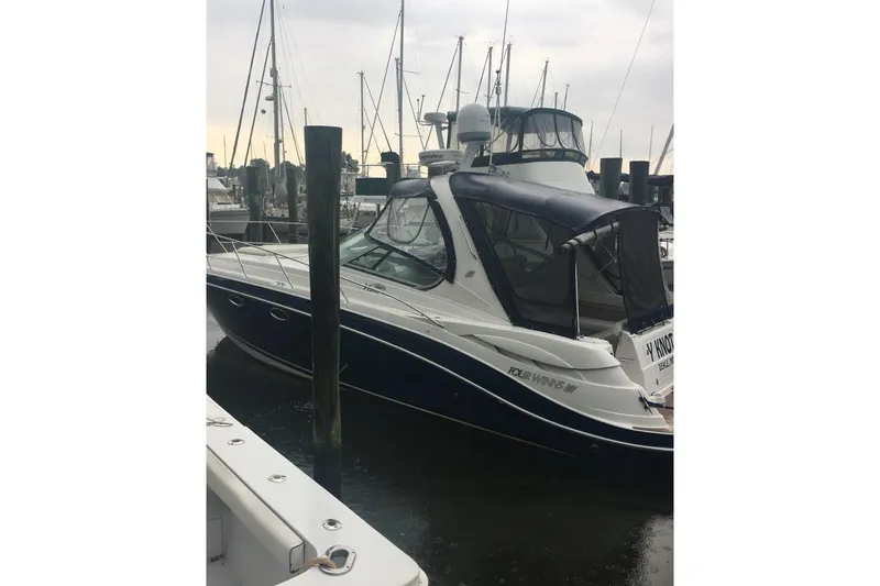 Slide: The Image of 2006 Four Winds Vista 348 boat docked at marina with overcast sky. - 12