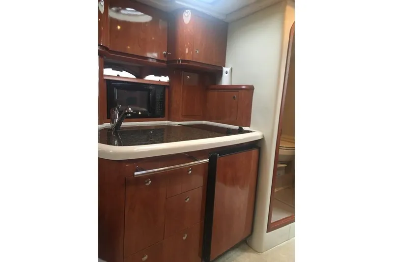 Slide: The Image of 2006 Four Winds Vista 348 RV kitchen with wood cabinetry and compact appliances. - 17