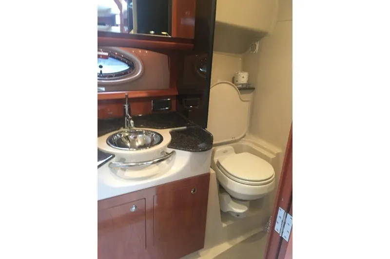 Slide: The Image of 2006 Four Winds Vista 348 bathroom with sink, toilet, and wooden cabinetry. - 18