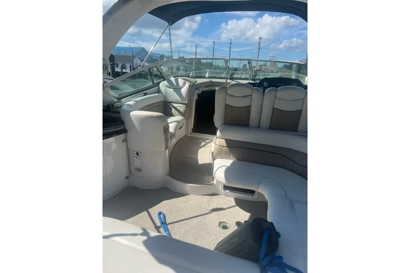 Slide: The Image of 2006 Four Winds Vista 348 boat interior with plush seating and open deck under blue sky. - 21