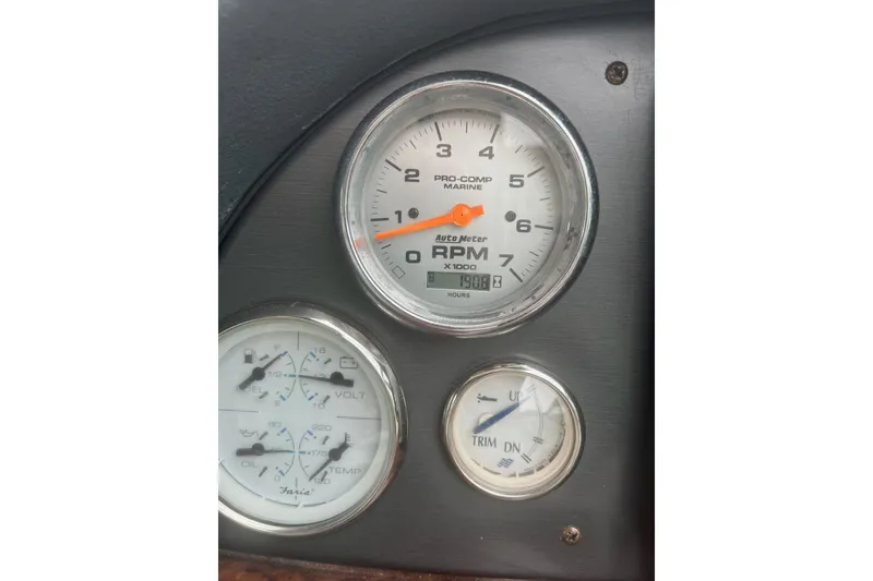 Slide: The Image of Dashboard gauges of a 2006 Four Winds Vista 348 boat, showing RPM, fuel, and trim indicators. - 22