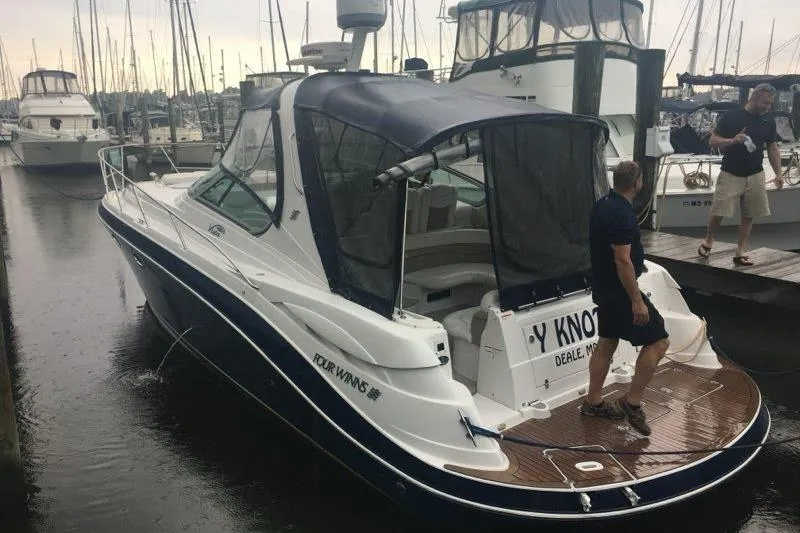 Slide: The Image of 2006 Four Winds Vista 348 boat docked at marina with people on deck. - 27