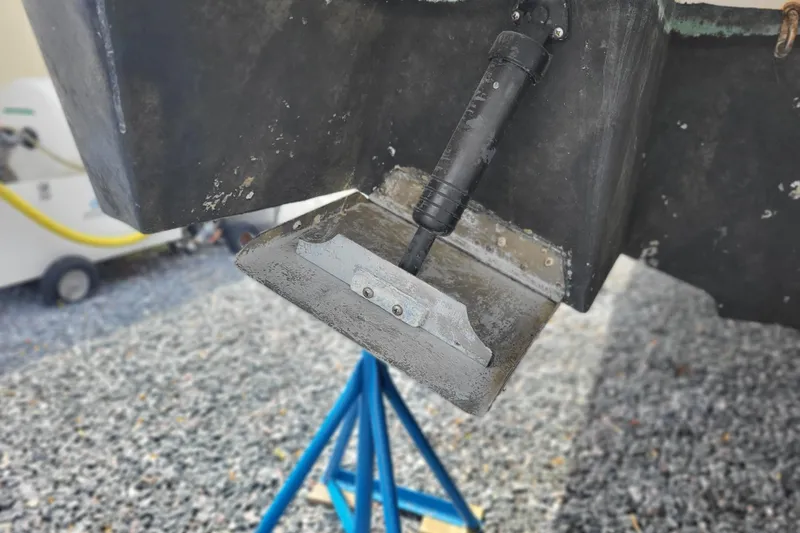 Slide: The Image of Close-up of a 2006 Four Winds Vista 348 boat's trim tab on a gravel surface. - 29