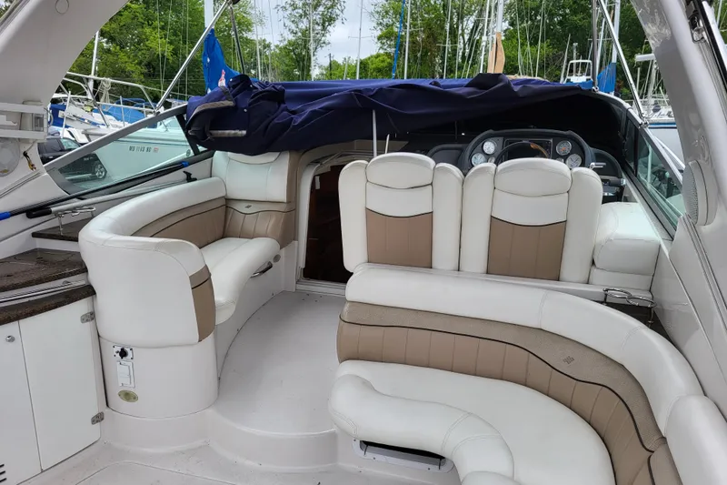 Slide: The Image of 2006 Four Winns 348 Vista boat interior with plush seating and dashboard view. - 31