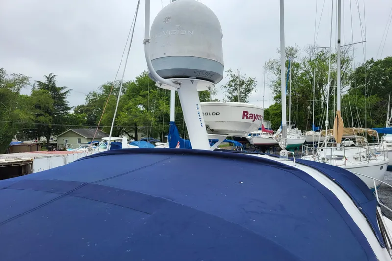 Slide: The Image of 2006 Four Winns 348 Vista boat with radar equipment, docked among sailboats. - 32