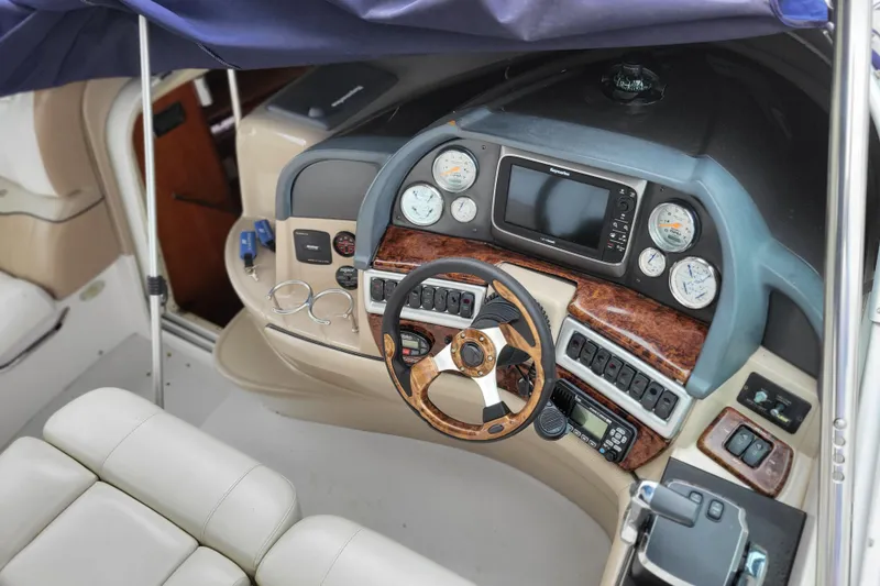 Slide: The Image of 2006 Four Winns 348 Vista boat cockpit with steering wheel and navigation instruments. - 33